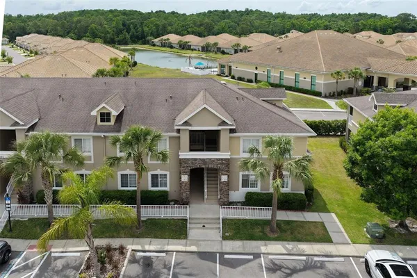 an aerial view of multiple houses with a yard