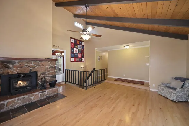 a bedroom with a bed and a flat tv screen on the dresser