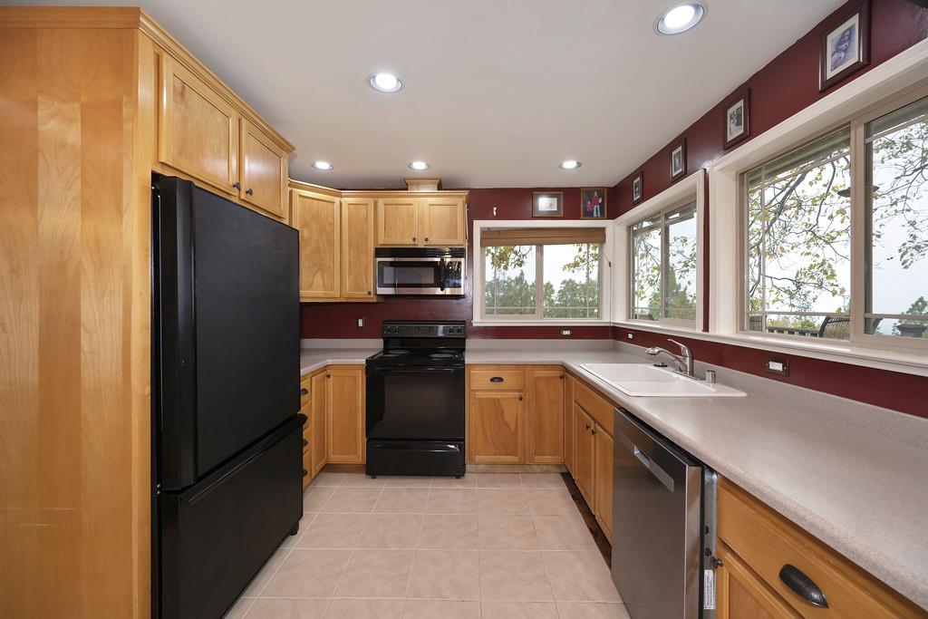 2930 Holloway Drive Georgetown, CA 95634 - Photo 22 of 93 a kitchen with stainless steel appliances granite countertop refrigerator sink and wooden cabinets