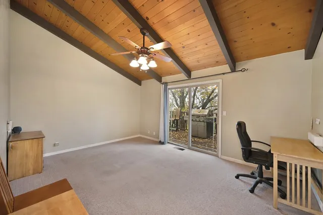 a balcony with wooden floor and fence