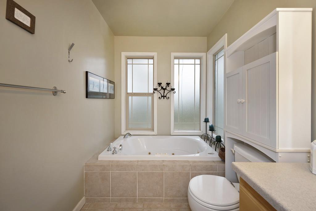 2930 Holloway Drive Georgetown, CA 95634 - Photo 36 of 93 a bathroom with a granite countertop toilet sink and bathtub