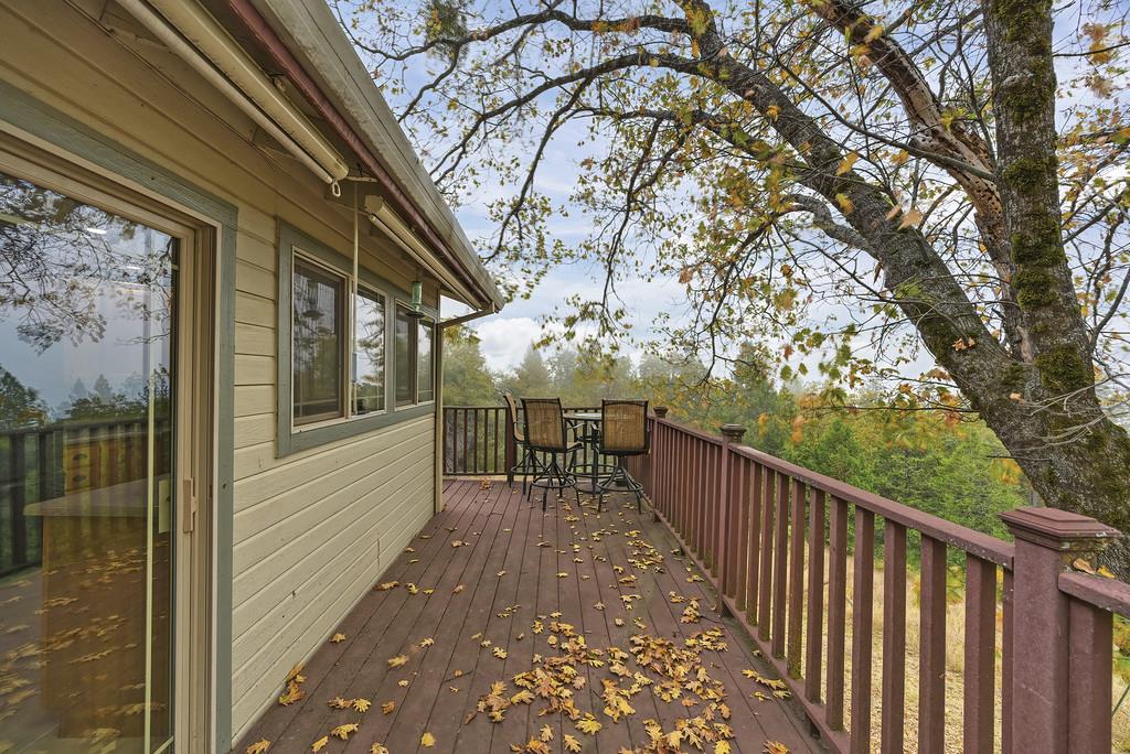 2930 Holloway Drive Georgetown, CA 95634 - Photo 53 of 93 a balcony with wooden floor and trees in front of it