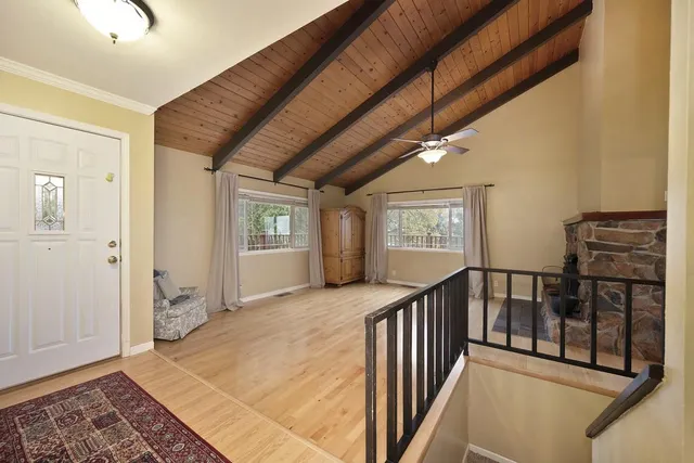 a large kitchen with stainless steel appliances granite countertop a large counter top space a sink and a refrigerator