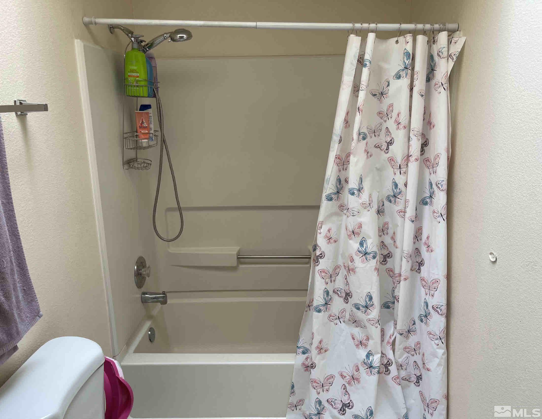 703 Empire Road Dayton, NV 89403 - Photo 17 of 31 a bathroom with a bathtub and shower