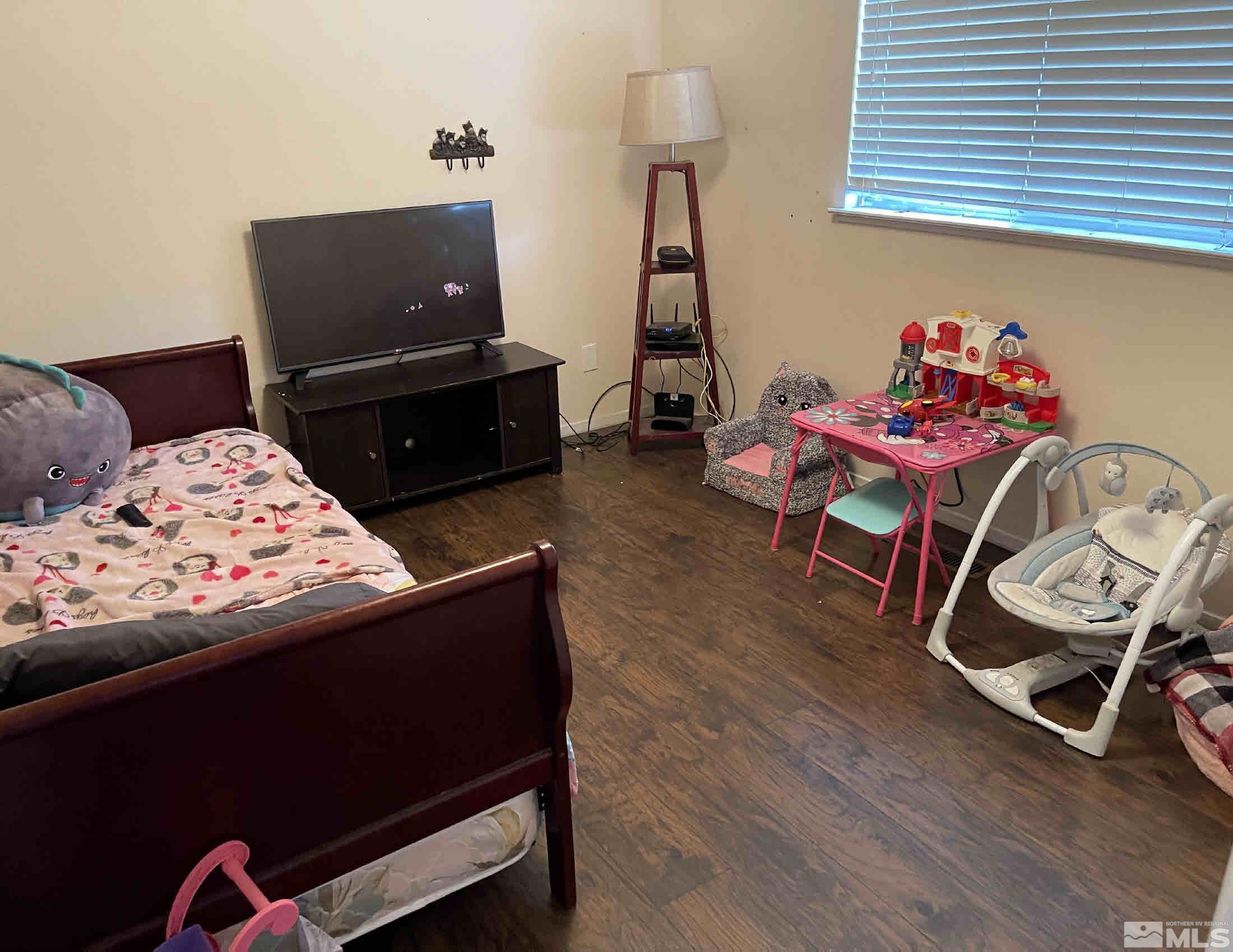 703 Empire Road Dayton, NV 89403 - Photo 18 of 31 a bedroom with furniture and a wooden floor