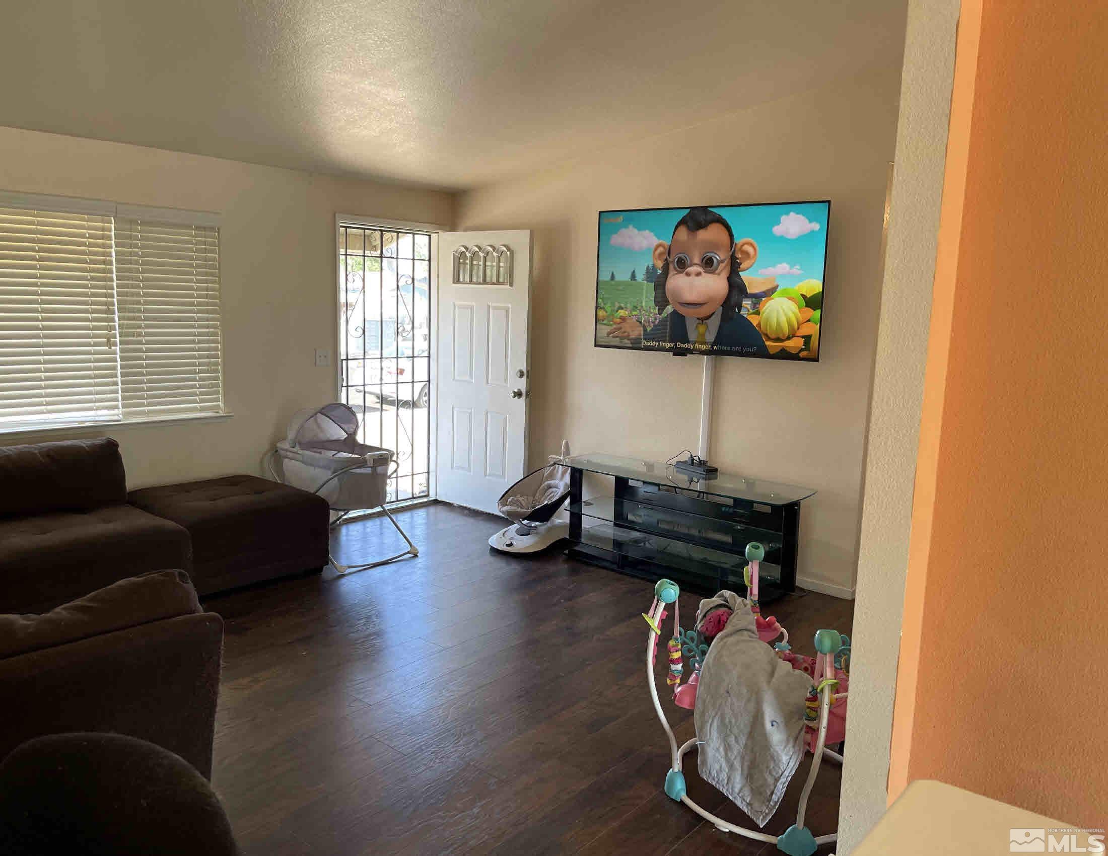 703 Empire Road Dayton, NV 89403 - Photo 2 of 31 a living room with furniture and a flat screen tv