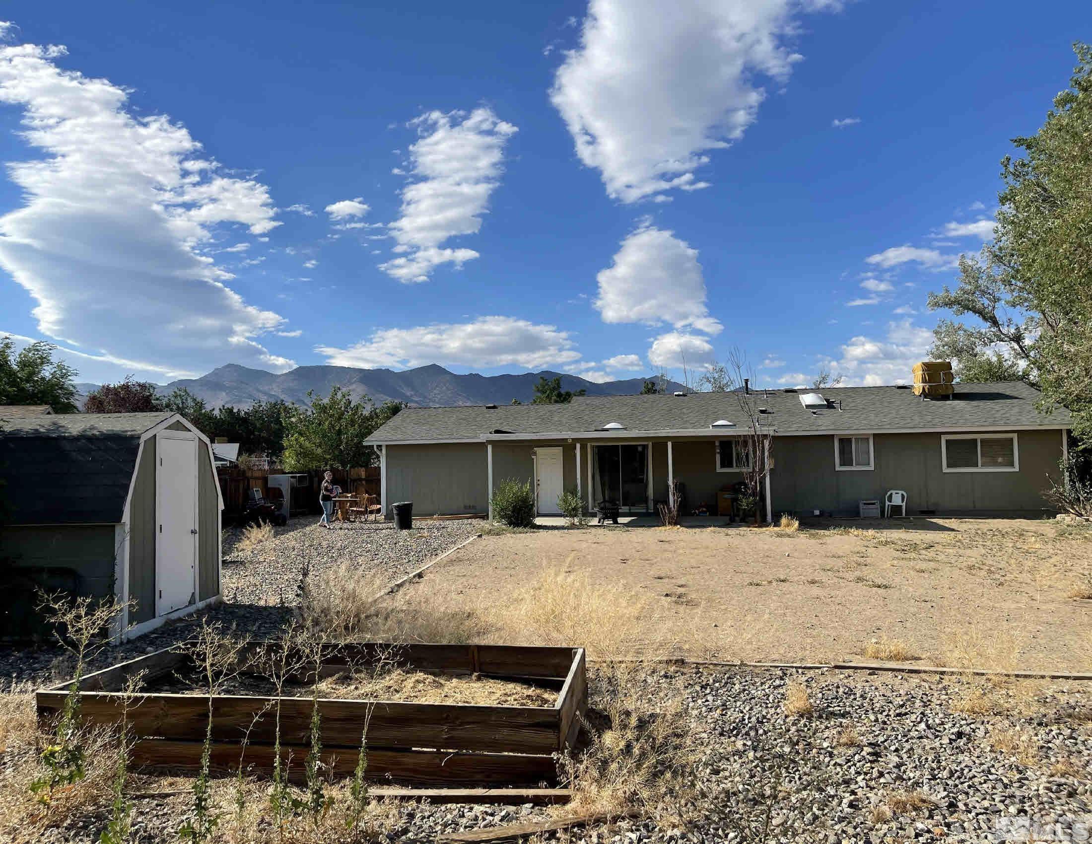 703 Empire Road Dayton, NV 89403 - Photo 23 of 31 a front view of a house with a yard covered with trees