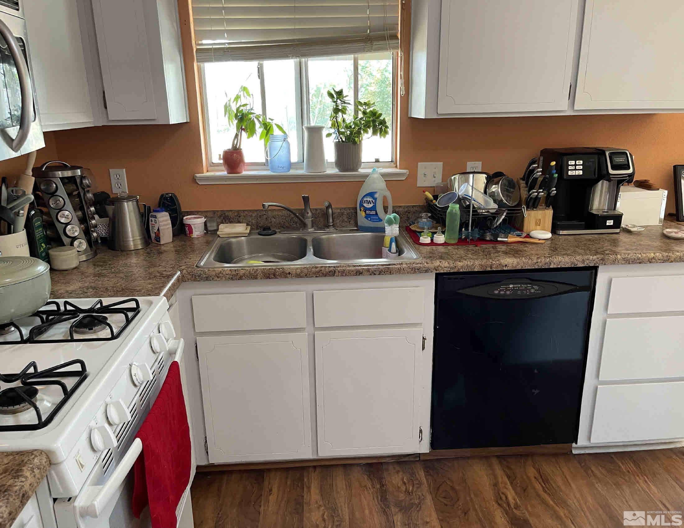 703 Empire Road Dayton, NV 89403 - Photo 9 of 31 a kitchen with a sink a stove and cabinets