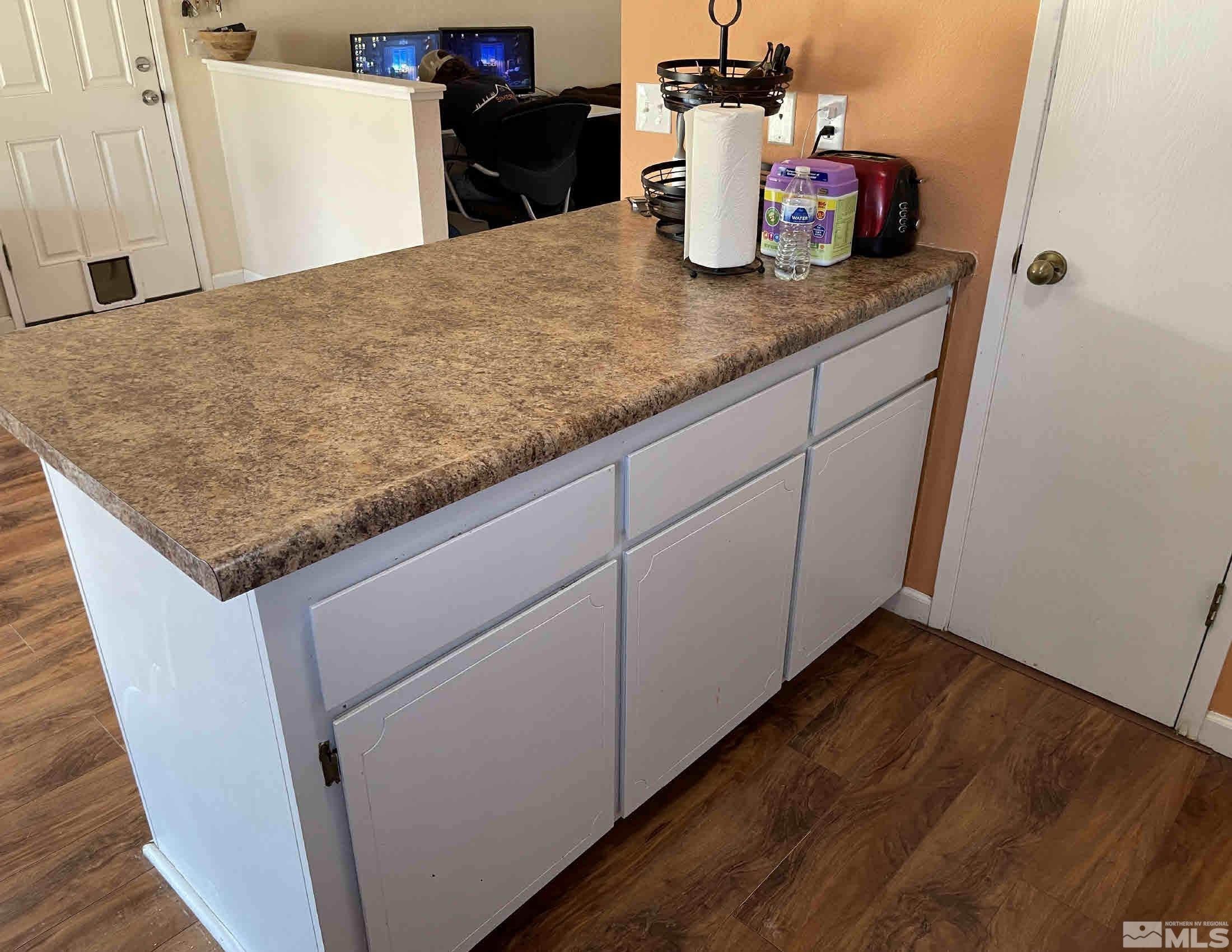 703 Empire Road Dayton, NV 89403 - Photo 10 of 31 a kitchen with granite countertop cabinets and wooden floor