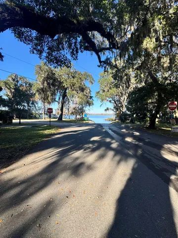 a view of a house with a yard chairs and a table under an umbrella