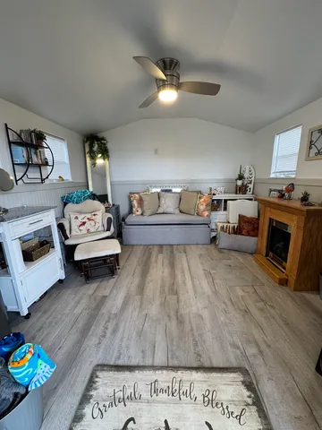 a living room with furniture and a wooden floor