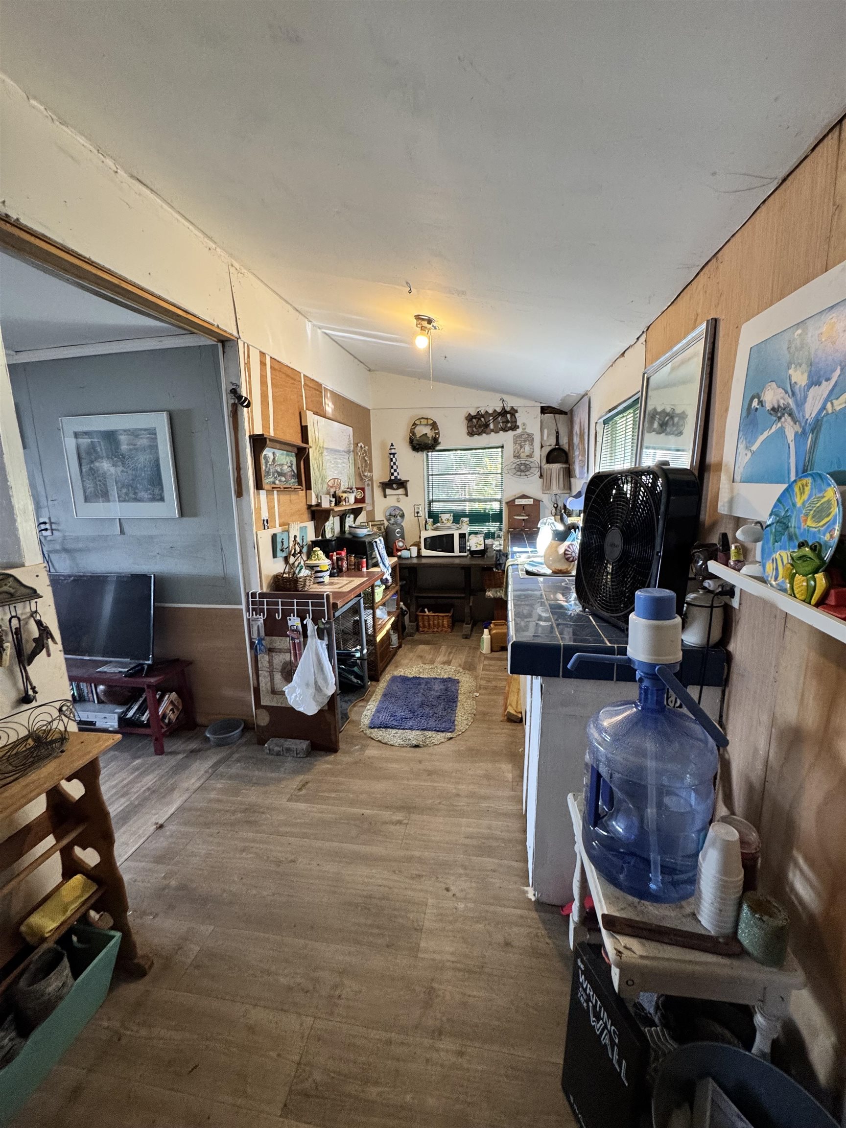 8550 Palmo Fish Camp Road, Unit 1 St. Augustine, FL 32092 - Photo 17 of 20 a living room with furniture a window and gym equipment