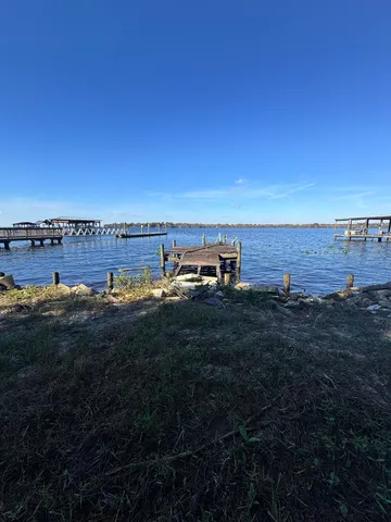a view of a lake with houses in back