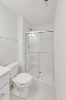 a bathroom with a toilet and a shower