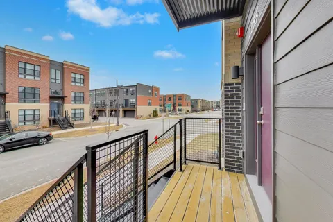 a view of balcony with a sink and wooden floor