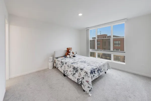 a bed sitting in a room next to a window