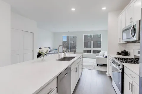 a kitchen with sink and stove top oven