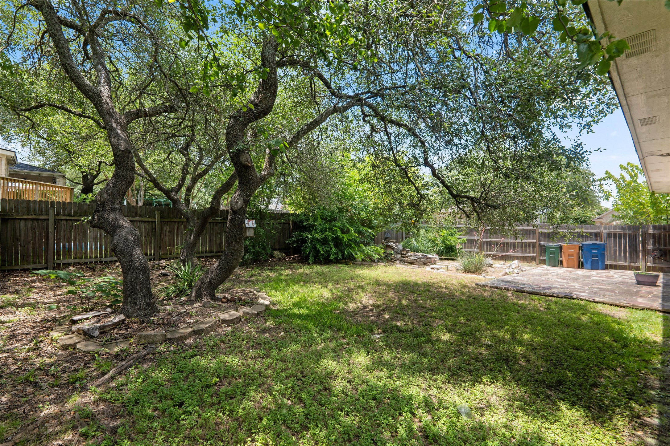 7000 Colberg Court Austin, TX 78749 - Photo 39 of 40 A verdant backyard retreat offers mature trees and a private patio.