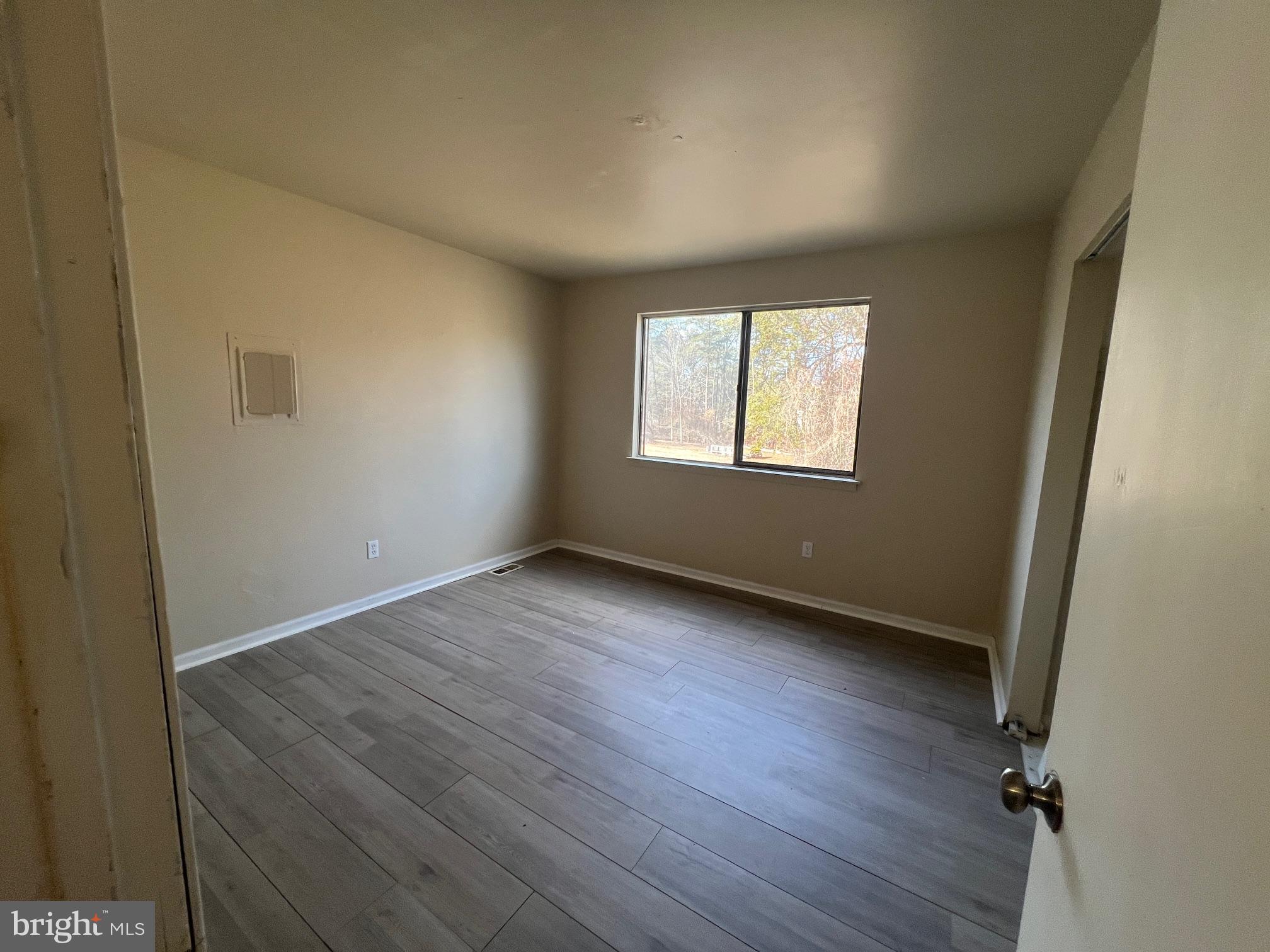 785 Jarvis Road, Unit A Sicklerville, NJ 08081 - Photo 7 of 10 an empty room with wooden floor and windows