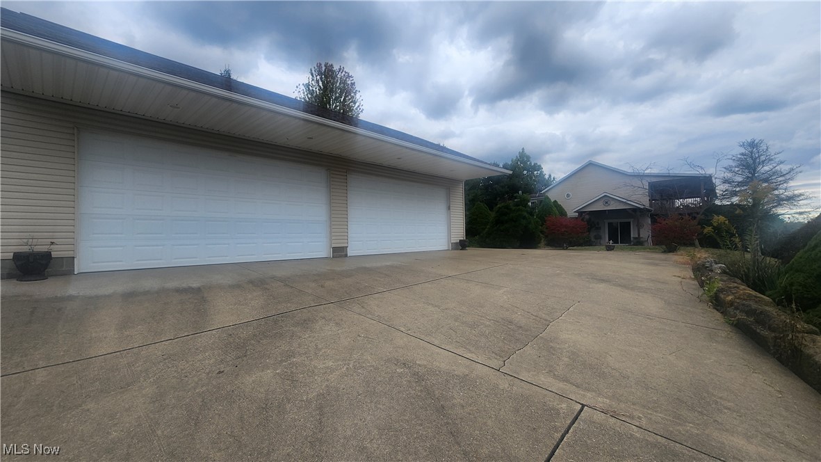 8000 Hawk Road Newcomerstown, OH 43832 - Photo 26 of 30 View of garage and house