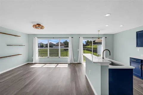 a view of a kitchen with a sink and a large window