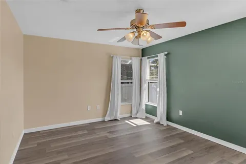 a bathroom with a granite countertop sink toilet a large mirror a bathtub and shower