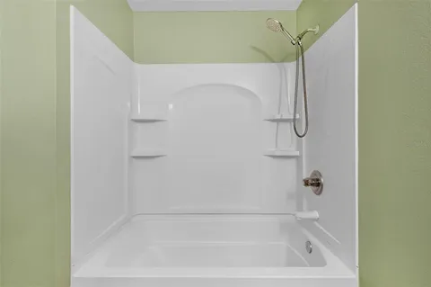 an aerial view of residential houses with outdoor space and ocean view