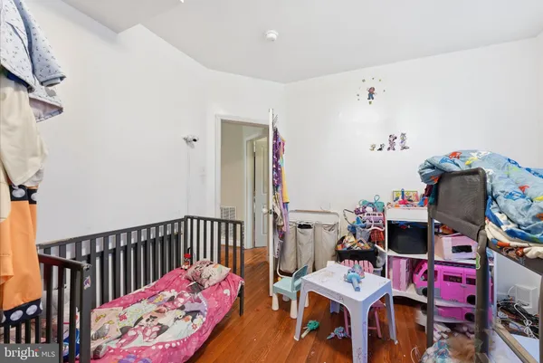 a bedroom with furniture and a baby crib