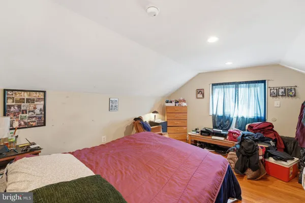 a bedroom with bed and a window