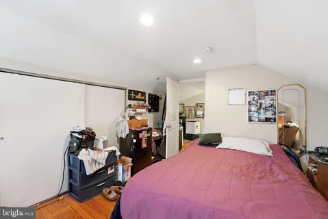 a bedroom with a bed and a desk