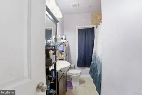 a bathroom with a toilet a sink and a mirror