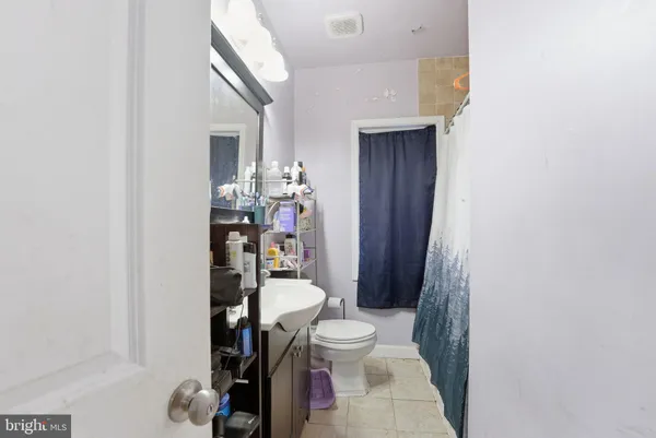 a bathroom with a toilet a sink and a mirror