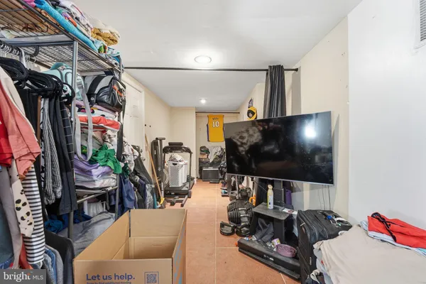 a room with gym equipment and a flat screen tv