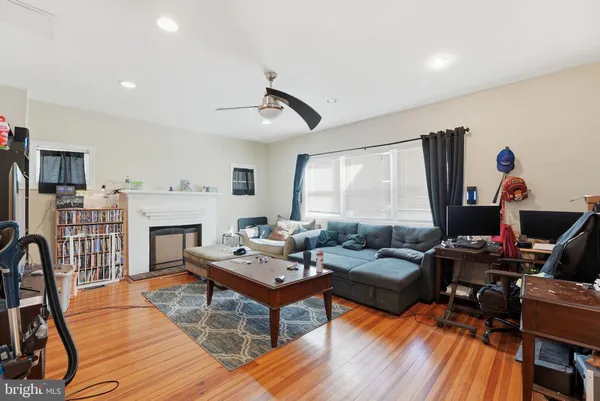 a living room with fireplace furniture and a flat screen tv