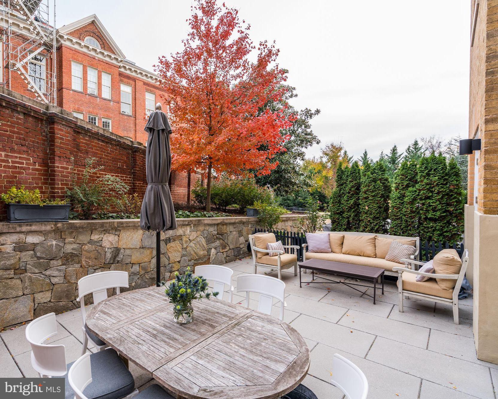 3052 R Street Northwest, Unit 102 Washington, DC 20007 - Photo 13 of 18 Large Patio Dining Table and Lounge Area