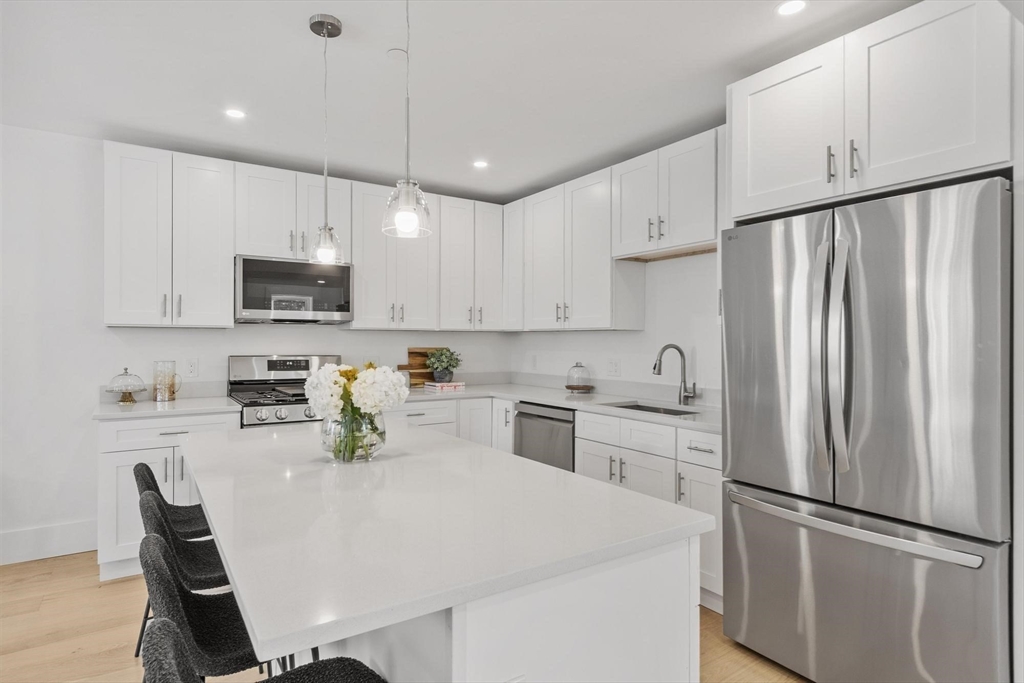 79 Maple Street, Unit 3 Boston, MA 02136 - Photo 3 of 13 a kitchen with stainless steel appliances a refrigerator sink and microwave