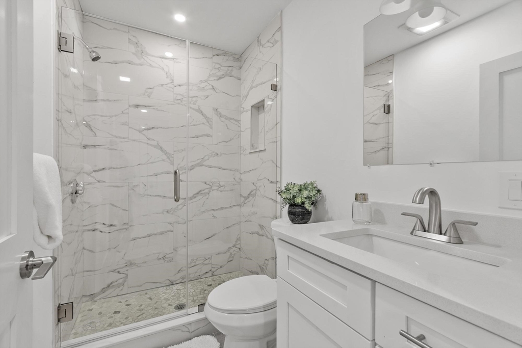 79 Maple Street, Unit 3 Boston, MA 02136 - Photo 8 of 13 a bathroom with a sink a toilet and shower
