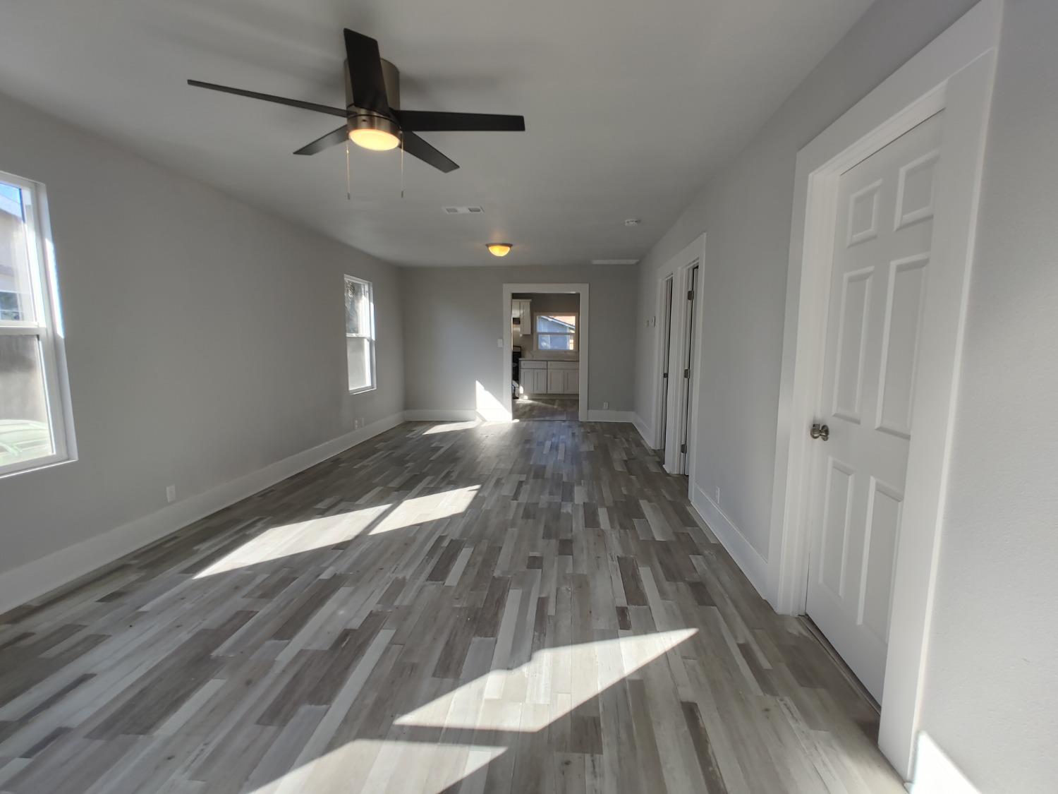 951 D Street Reedley, CA 93654 - Photo 3 of 25 a view of empty room with wooden floor and fan