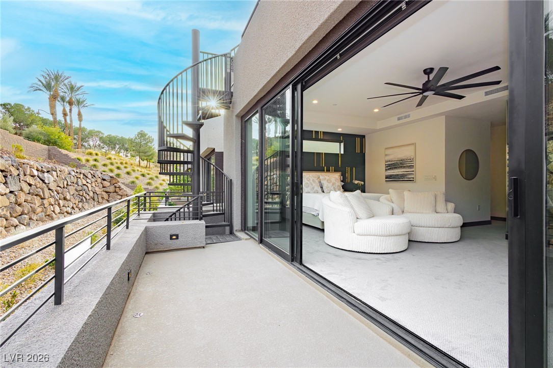 13 Promenade Isle Lane Henderson, NV 89011 - Photo 27 of 52 Balcony off Primary bedroom with a huge glass wall which opens to a private area