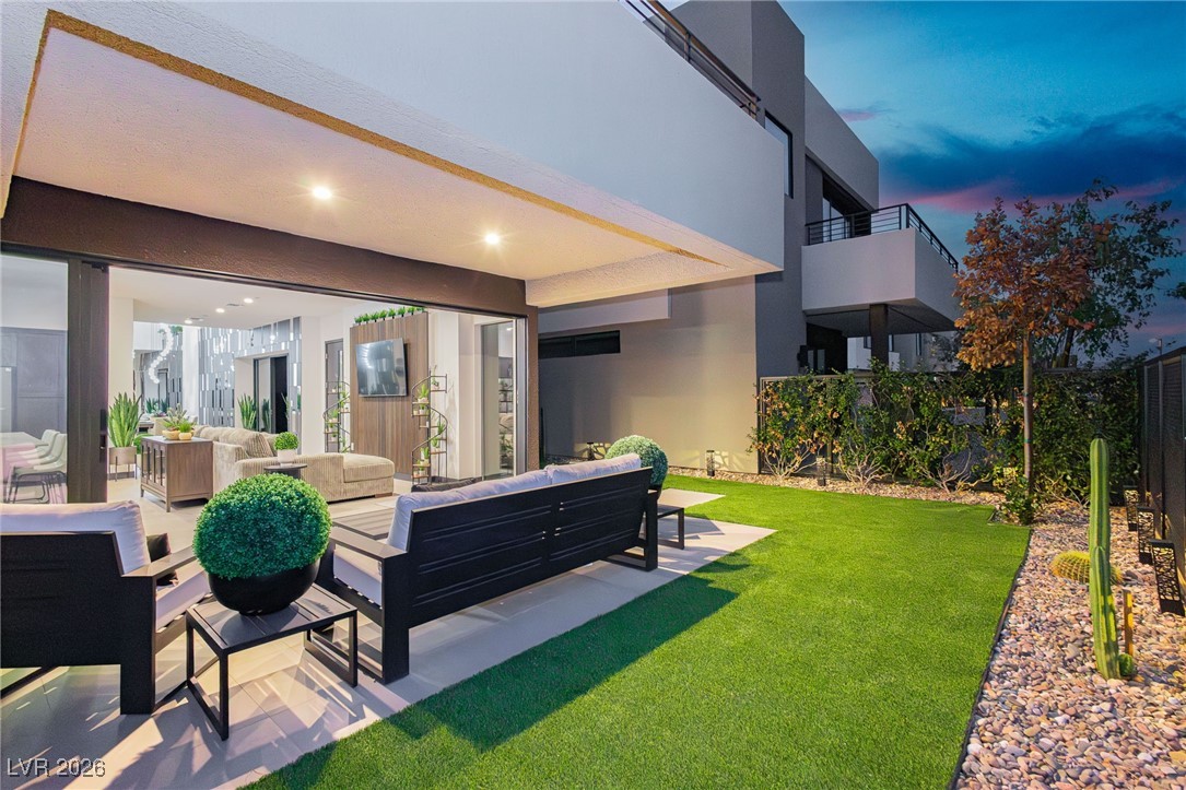 13 Promenade Isle Lane Henderson, NV 89011 - Photo 38 of 52 Covered Patio with glass walls from the kitchen and Great Room