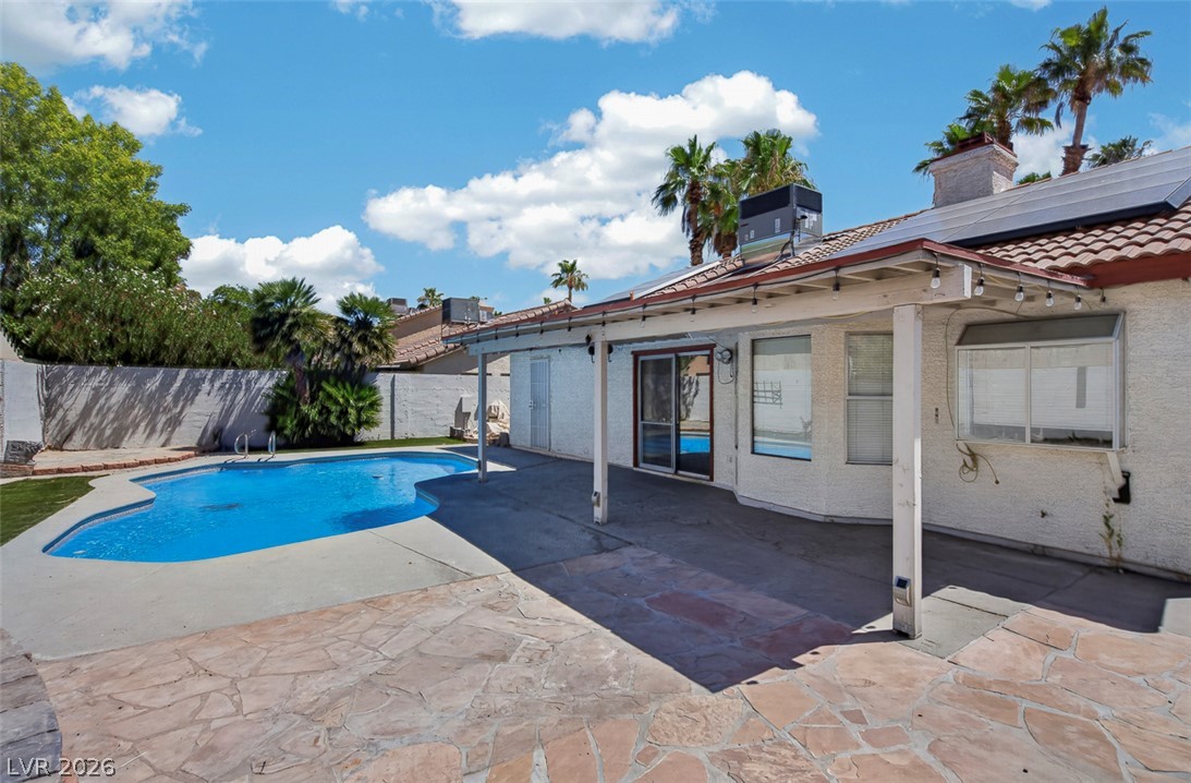 2609 Shakespeare Road Las Vegas, NV 89108 - Photo 33 of 41 An inviting backyard oasis offers a free-form pool and ample patio space for leisure.