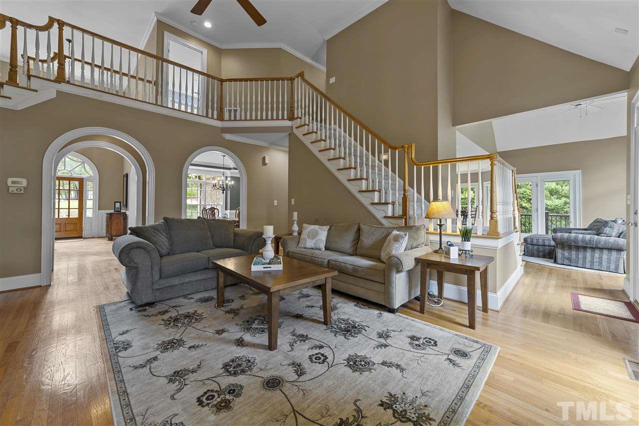 1126 Stonebridge Drive Durham, NC 27712 - Photo 17 of 29 a living room with couches a dining table and chairs with wooden floor