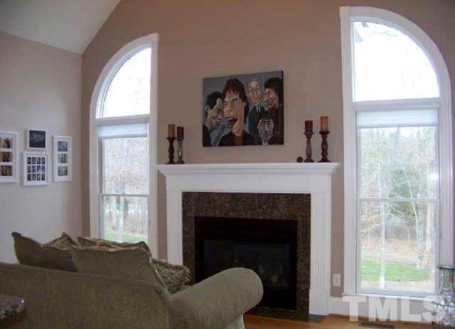 1126 Stonebridge Drive Durham, NC 27712 - Photo 3 of 29 a living room with a fireplace and a large window