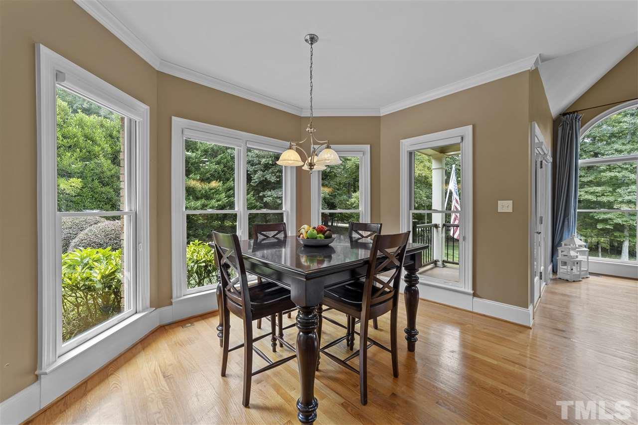 1126 Stonebridge Drive Durham, NC 27712 - Photo 21 of 29 a view of a dining room with furniture window and wooden floor