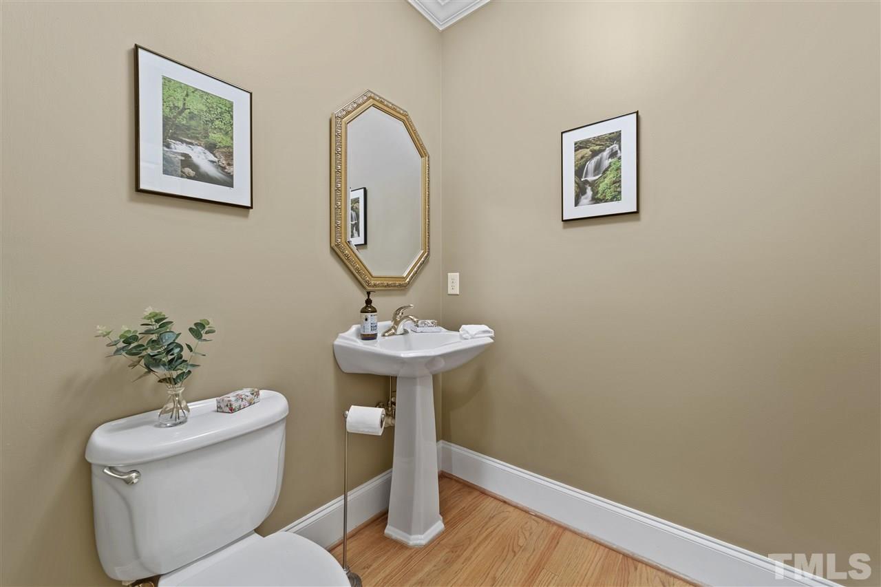 1126 Stonebridge Drive Durham, NC 27712 - Photo 22 of 29 a bathroom with a toilet a sink and mirror