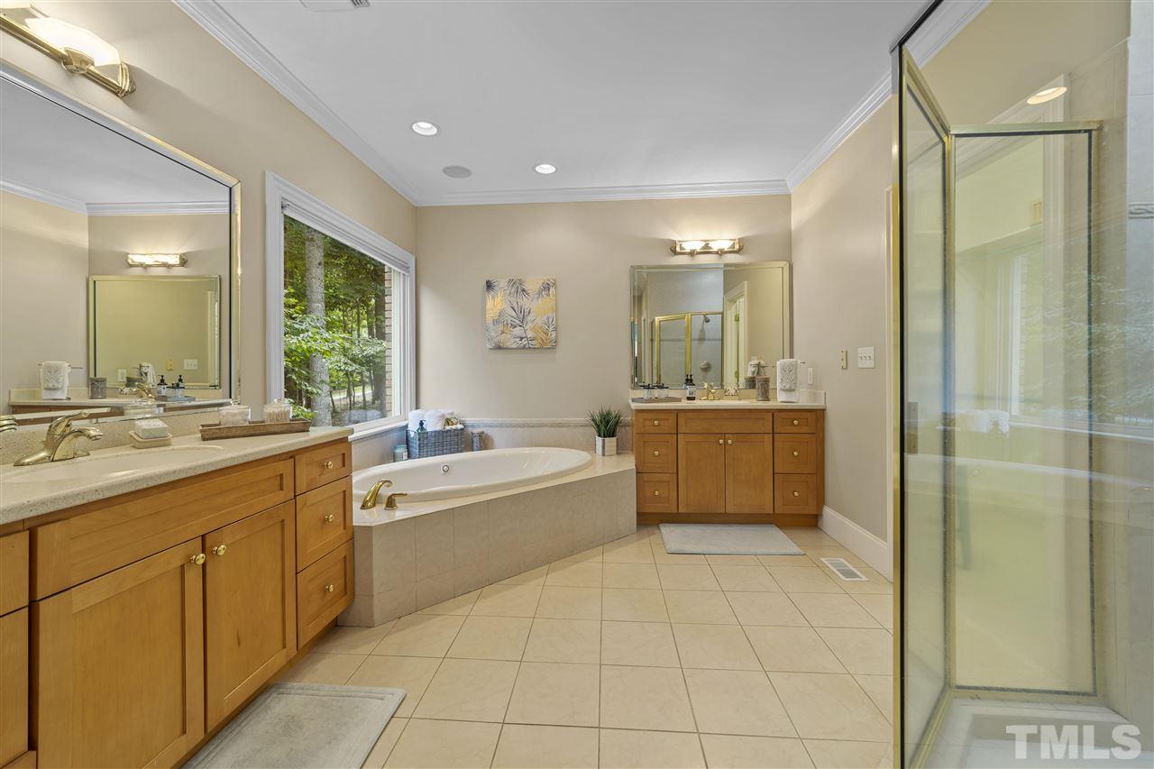 1126 Stonebridge Drive Durham, NC 27712 - Photo 23 of 29 a bathroom with a tub a sink shower and mirror