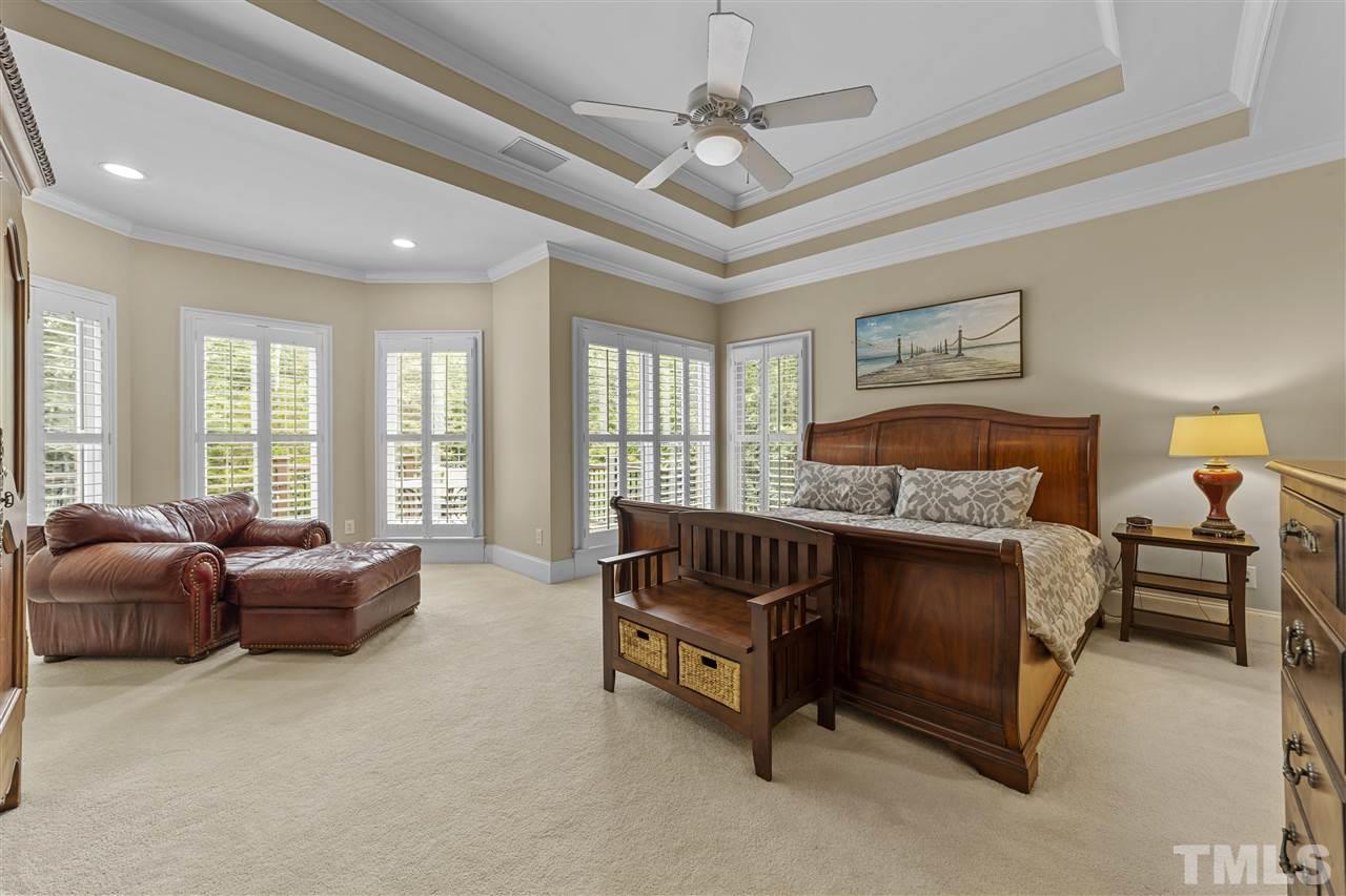 1126 Stonebridge Drive Durham, NC 27712 - Photo 24 of 29 a spacious bedroom with a bed and a couch