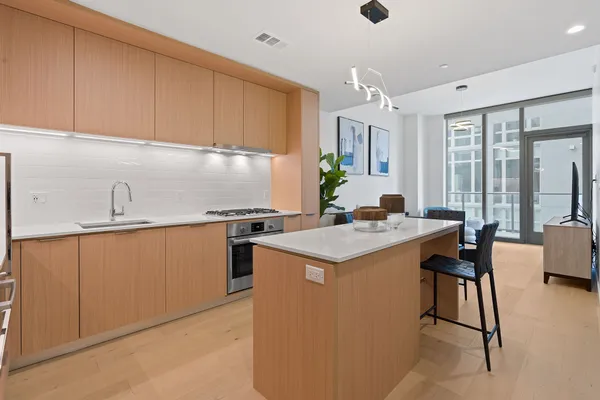 a kitchen with granite countertop a sink stove and cabinets