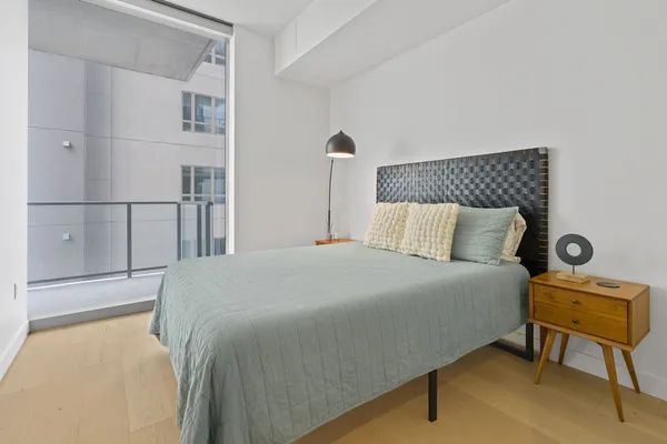 a bedroom with a bed and chair