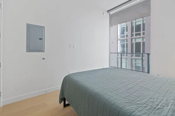 a bedroom with a bed and glass door